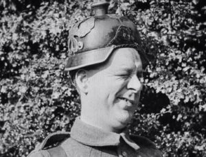 Still from 'Lads of the Village' film 1919 showing man in German helmet winking